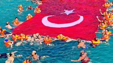 Çeşme’de kadınlar bayrağı denizin üzerinde dalgalandırdı
